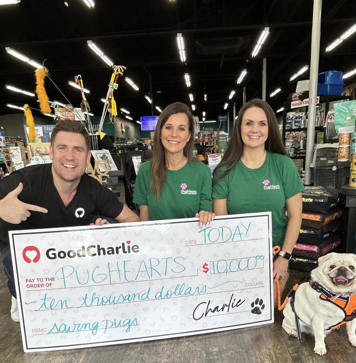 Daryl, cofounder of GoodCharlie, with two Pughearts representatives holding a cheque of $10,000 presented to Pughearts.